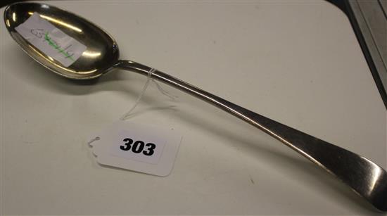 A silver basting spoon